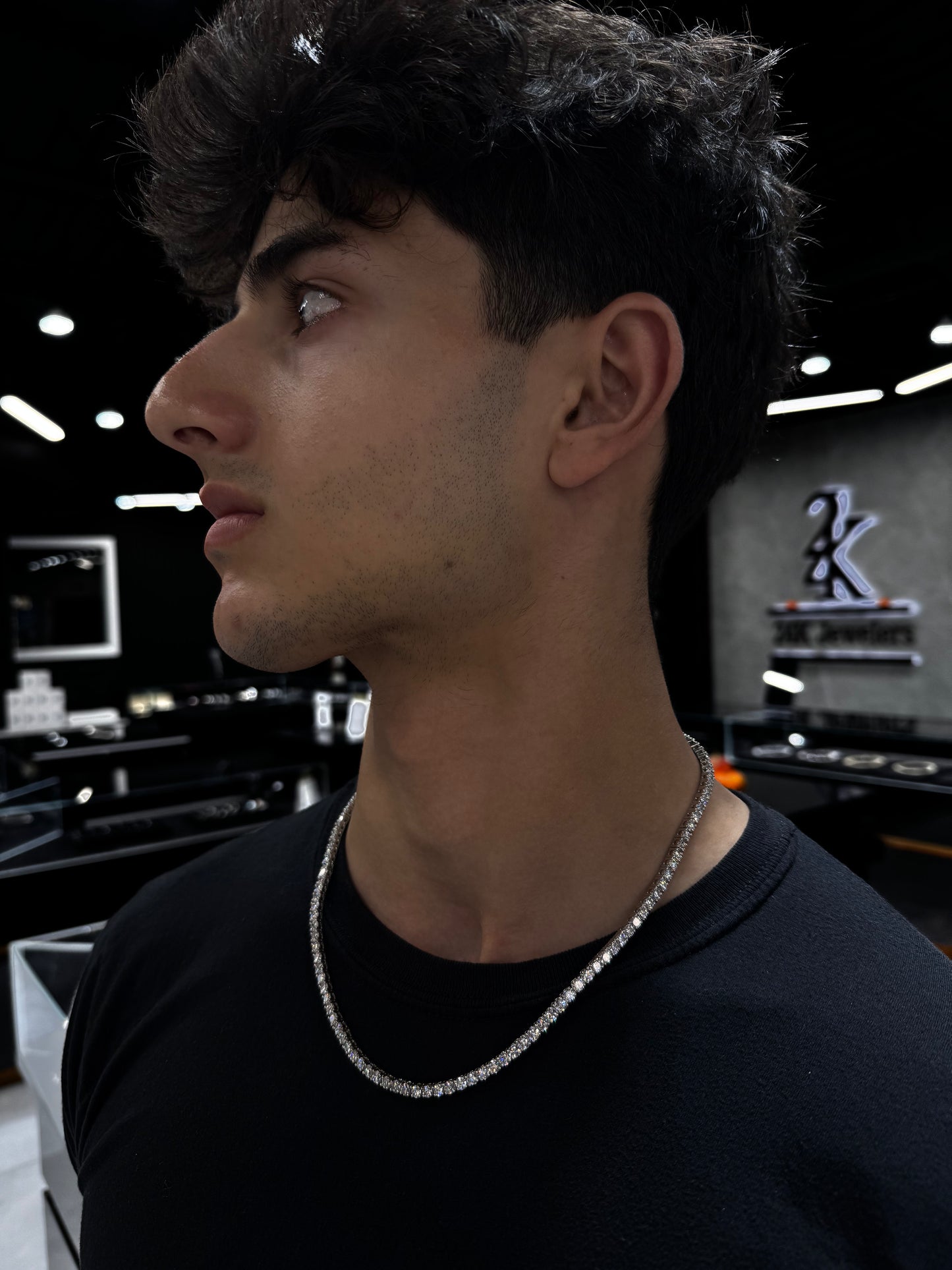 Male model wearing .925 silver 15 pointer lab diamond tennis chain styled for a bold, luxurious look