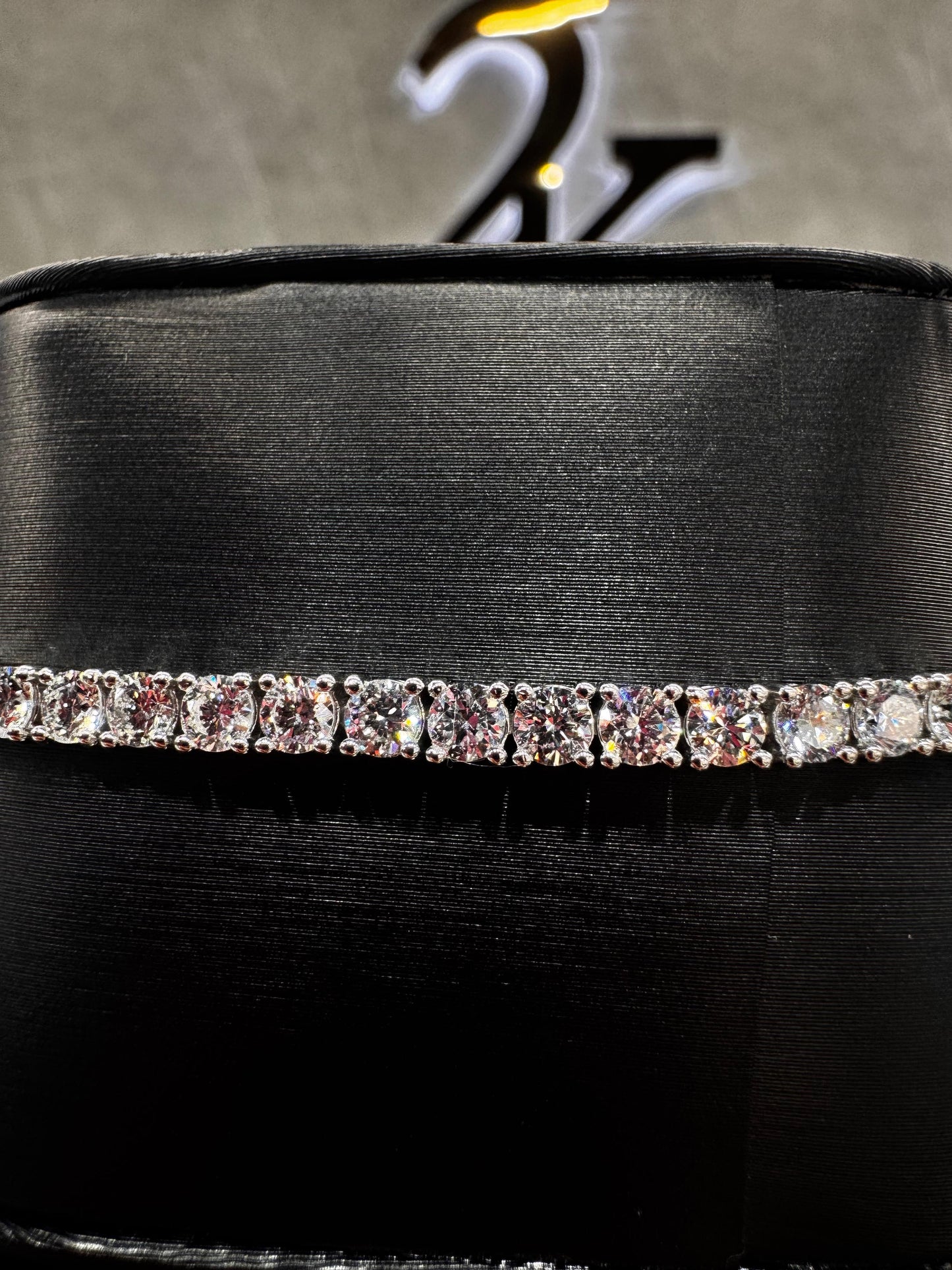Close-up of a 14K gold tennis bracelet featuring 15-point round diamonds, highlighting the precision setting and brilliance of each stone.