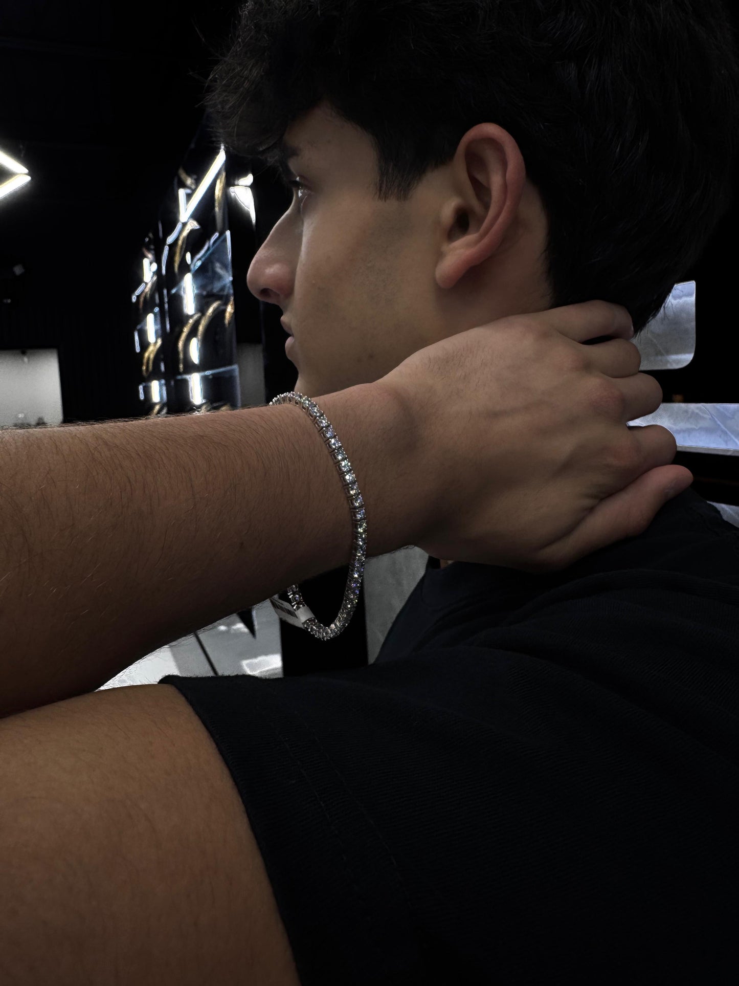 Male model wearing a 14K gold diamond tennis bracelet with 15-point diamonds, styled with a luxury watch for a refined, high-end look