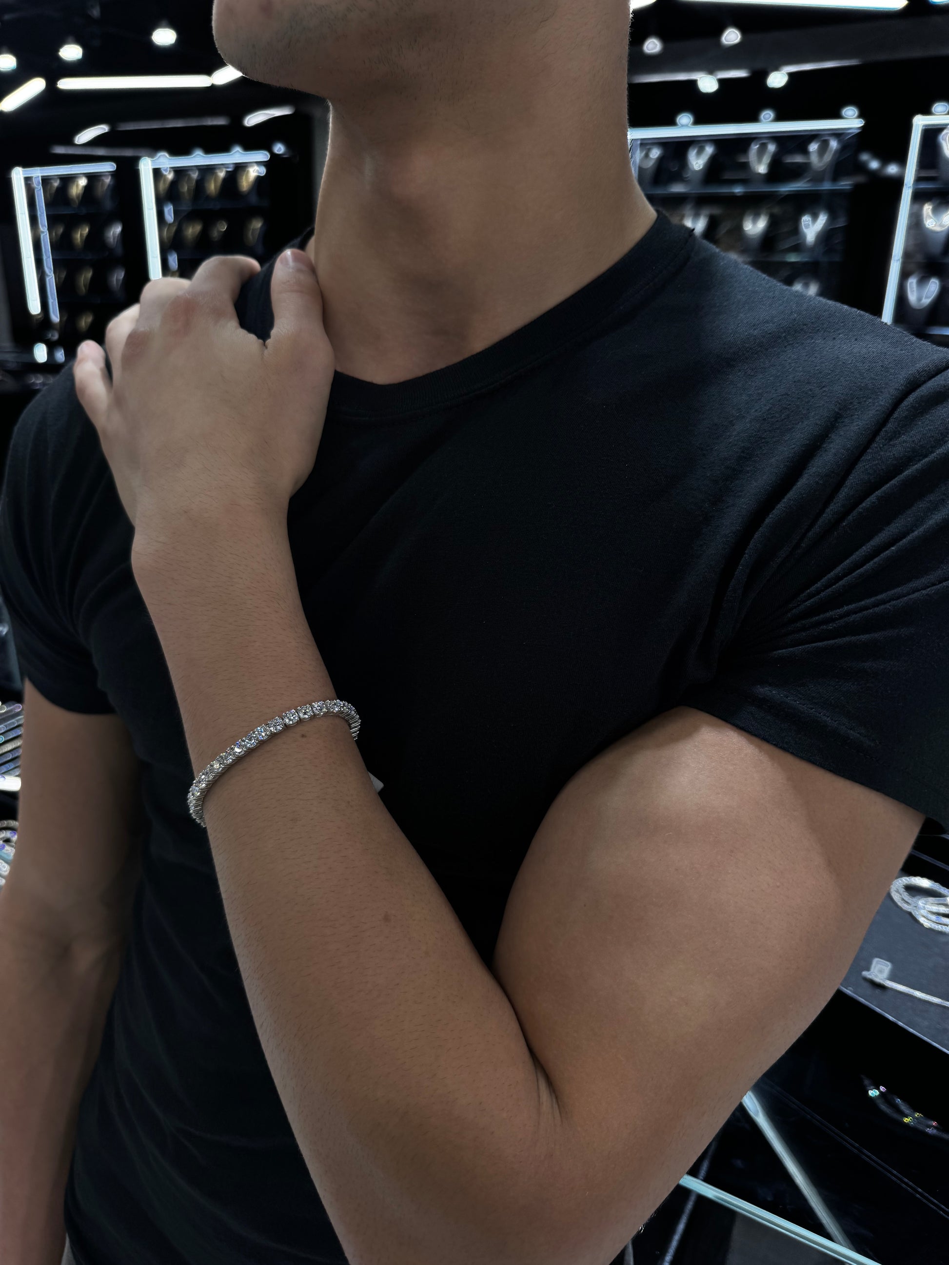 Male model wearing .925 silver 35 pointer lab diamond tennis bracelet styled for a bold, luxurious look