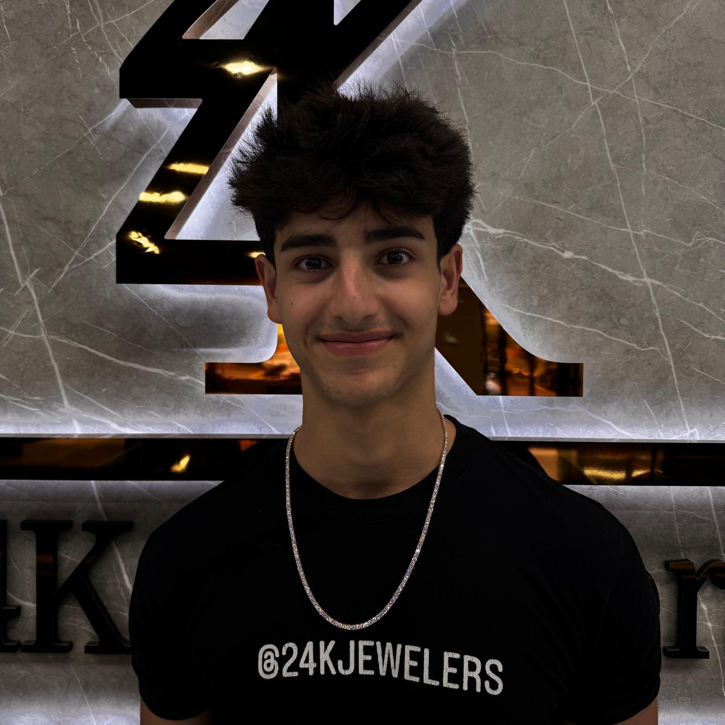 “Male model wearing a 20 pointer diamond tennis chain in 14K gold, showcasing round brilliant-cut diamonds with a bold, luxurious shine around the neck.”