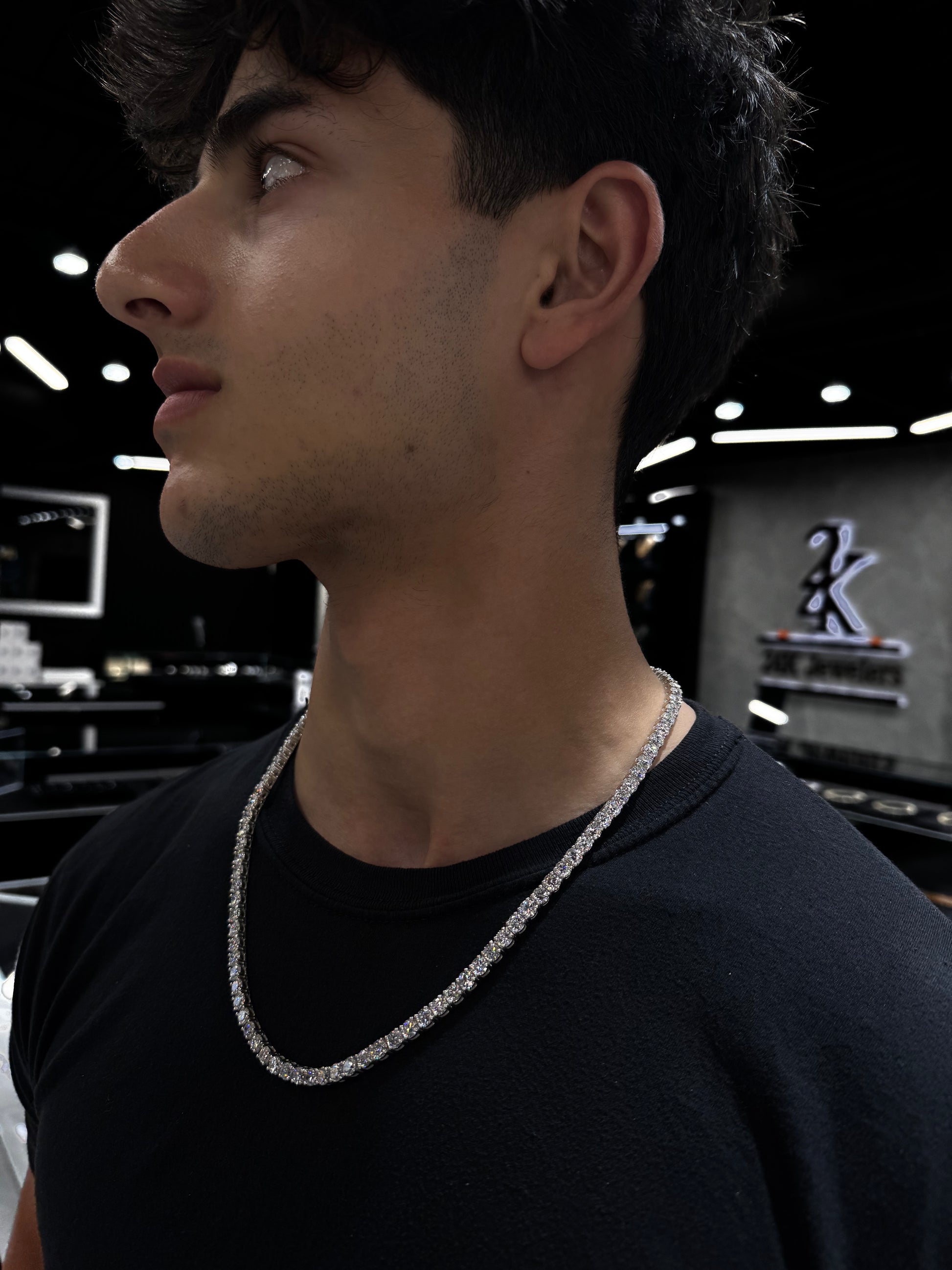 Male model wearing .925 silver 50 pointer lab diamond tennis chain styled for a bold, luxurious look