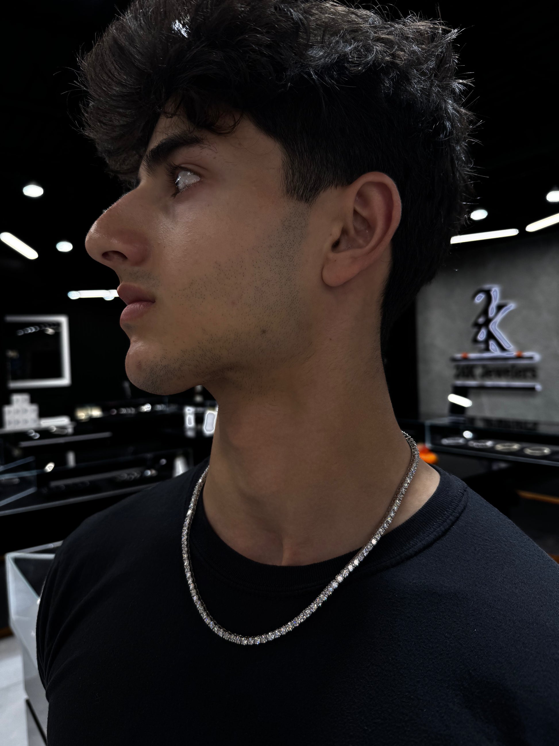 Male model wearing .925 silver 15 pointer lab diamond tennis chain styled for a bold, luxurious look