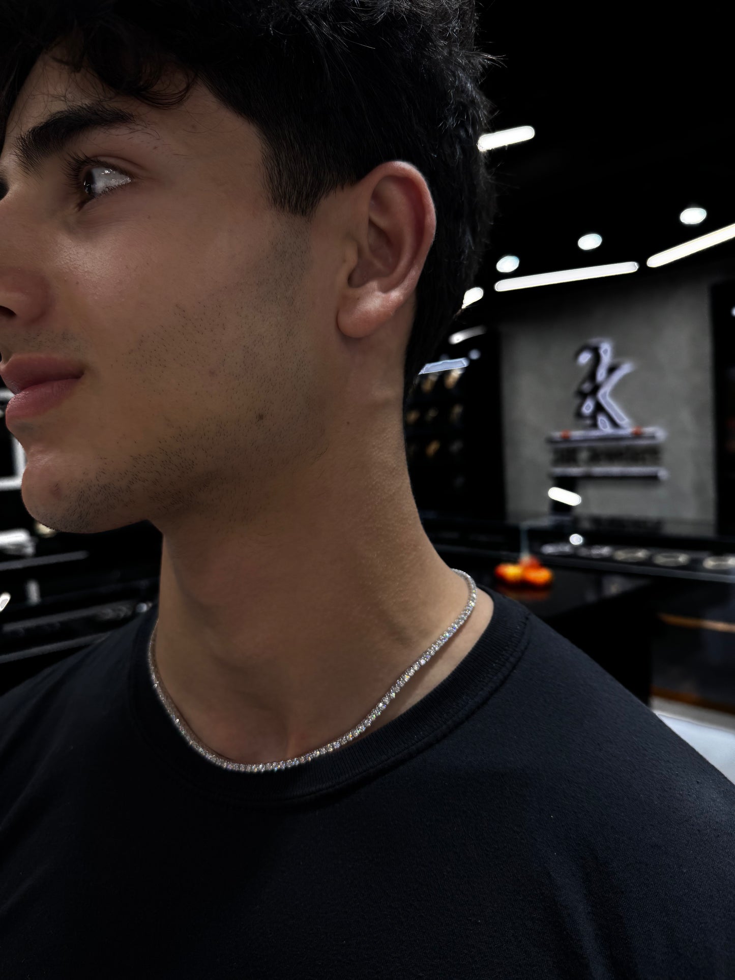 Male model wearing .925 silver 7 pointer lab diamond tennis chain styled for a bold, luxurious look