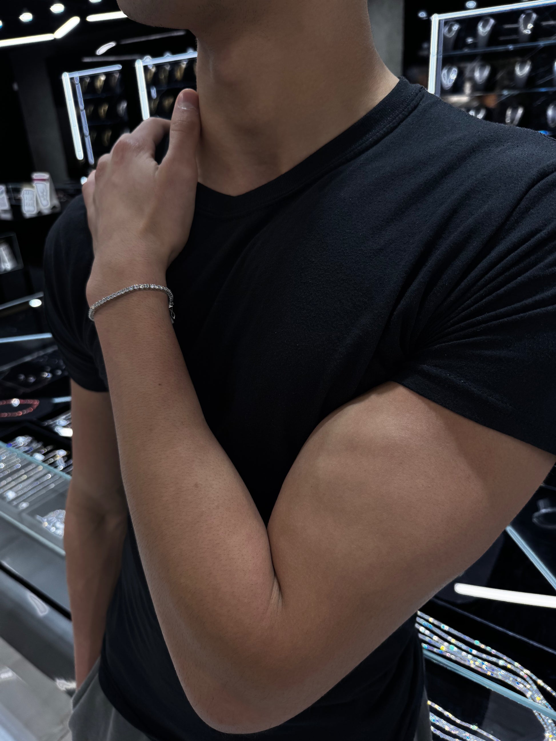 Male model wearing .925 silver 7 pointer lab diamond tennis bracelet styled for a sleek and luxurious look