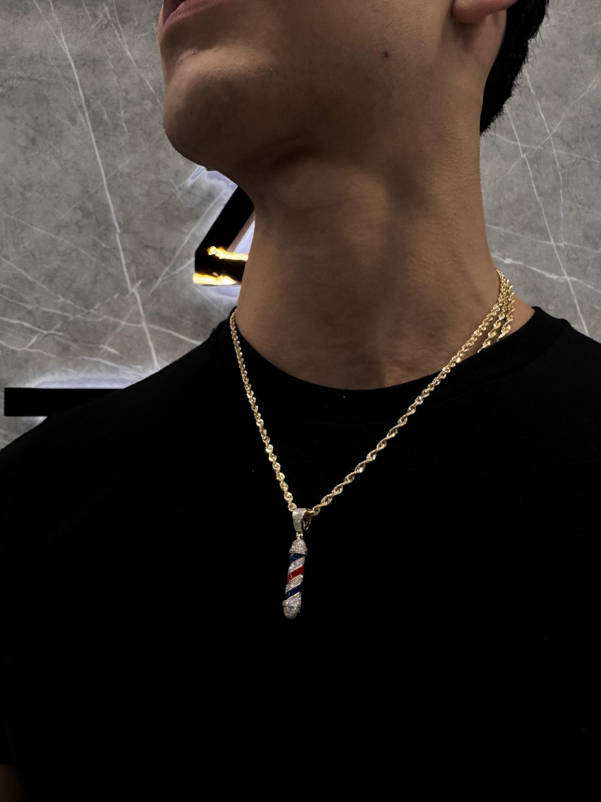 "Male model wearing a natural diamond barber pole pendant on a white gold chain, styled with streetwear to showcase bold, professional drip."