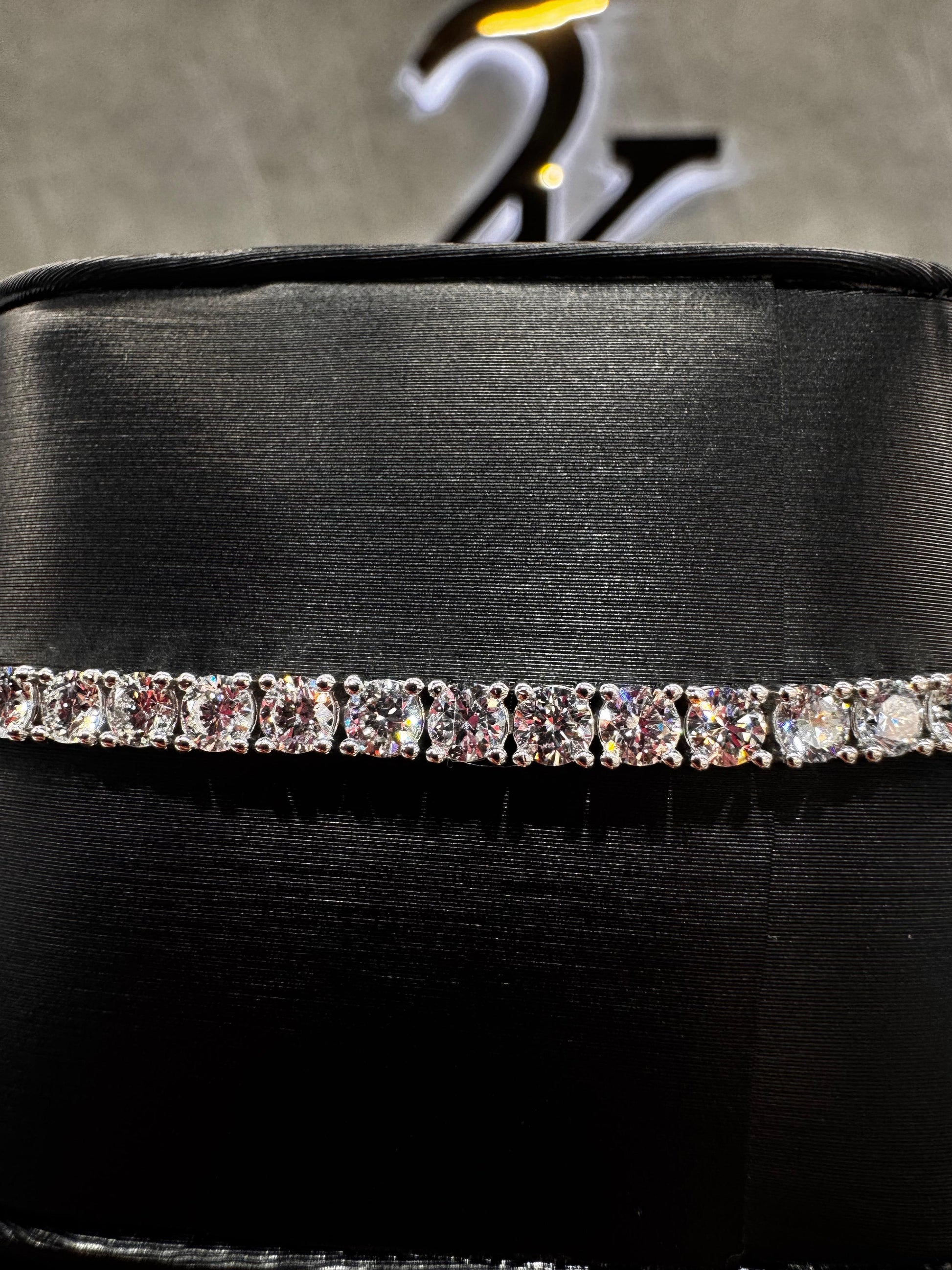 Close-up of a 14K gold tennis bracelet featuring 15-point round diamonds, highlighting the precision setting and brilliance of each stone.