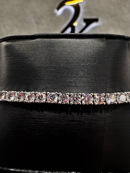 Close-up of a 14K gold tennis bracelet featuring 15-point round diamonds, highlighting the precision setting and brilliance of each stone.
