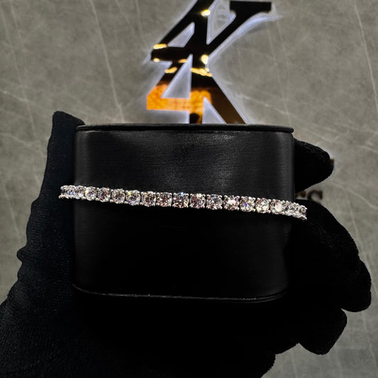 “8-inch diamond tennis bracelet with 25 pointer round brilliant-cut stones set in 14K gold, featuring a sleek and luxurious design.”