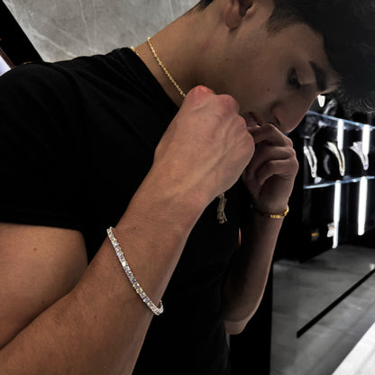 “Male model wearing 25 pointer diamond tennis bracelet in 14K gold, showcasing bold, luxurious sparkle and sleek wrist profile.”