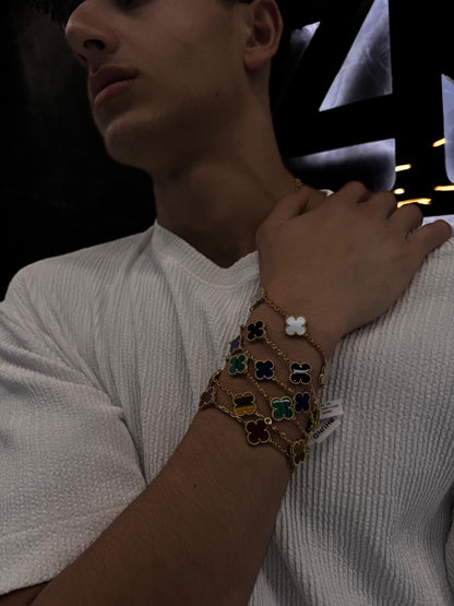 “Male model wearing a Van Cleef & Arpels bracelet on his wrist, styled with a sharp outfit to highlight the unisex sophistication and timeless appeal of the piece.”