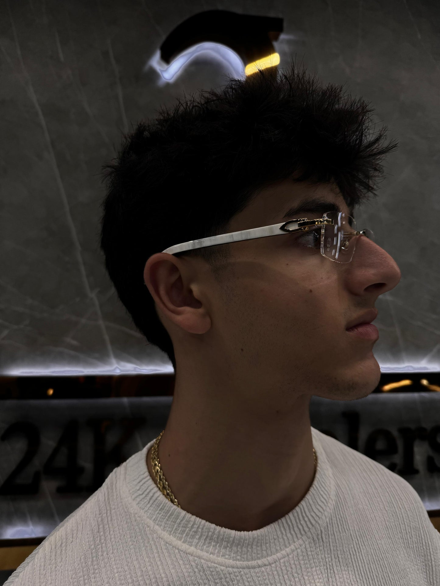 Male model wearing Cartier White S Ticks sunglasses, highlighting the sharp rectangular frame and white gold detailing with natural buffalo horn temples—blending luxury and street elegance.